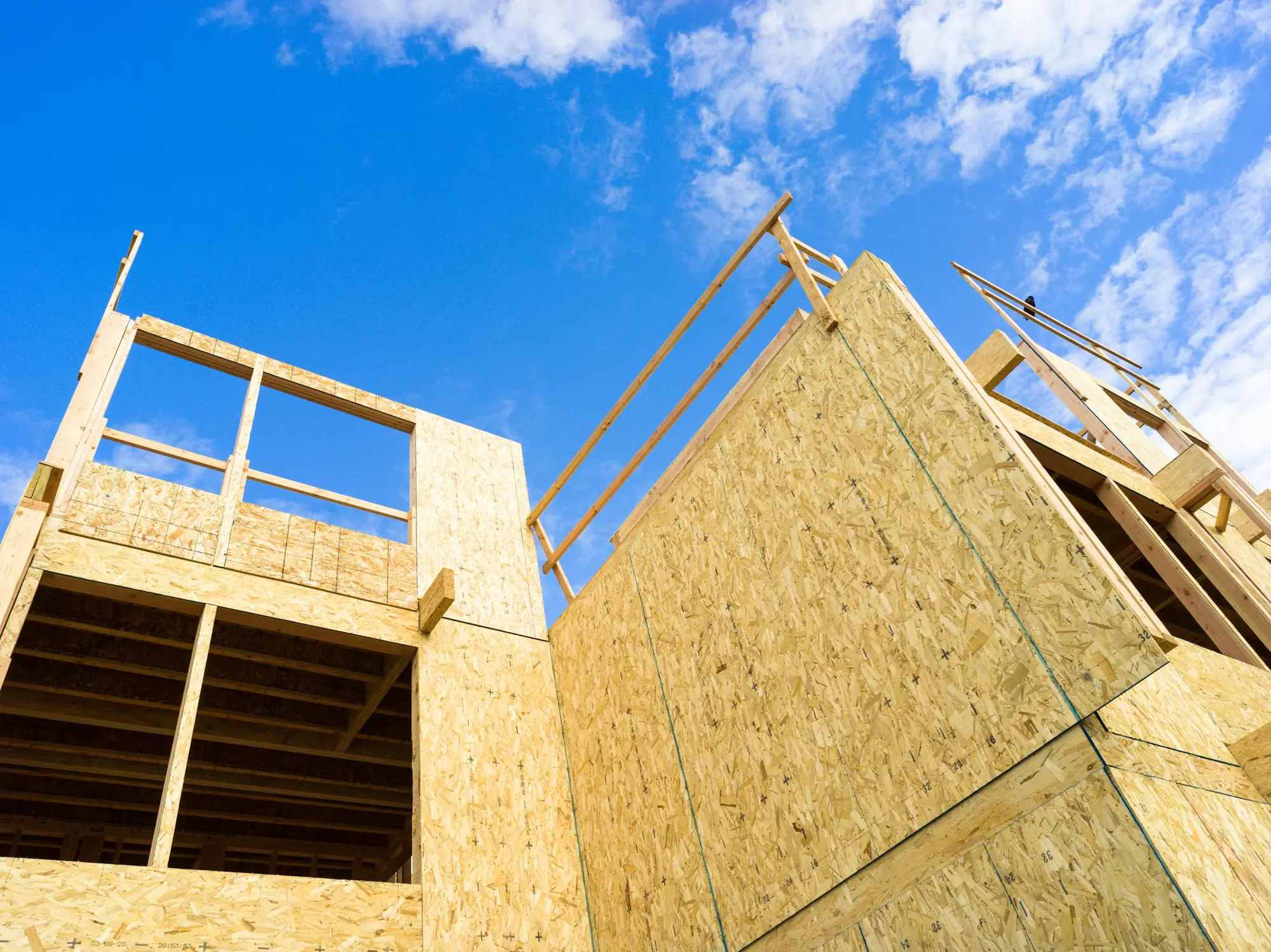 Roof trusses set on a new wood-framed addition