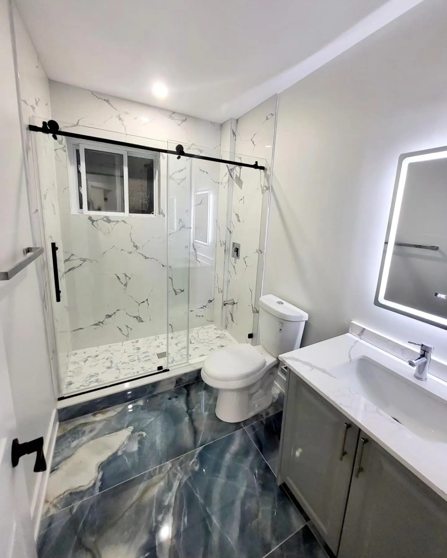 Bathroom with marble-look shower and epoxy floor