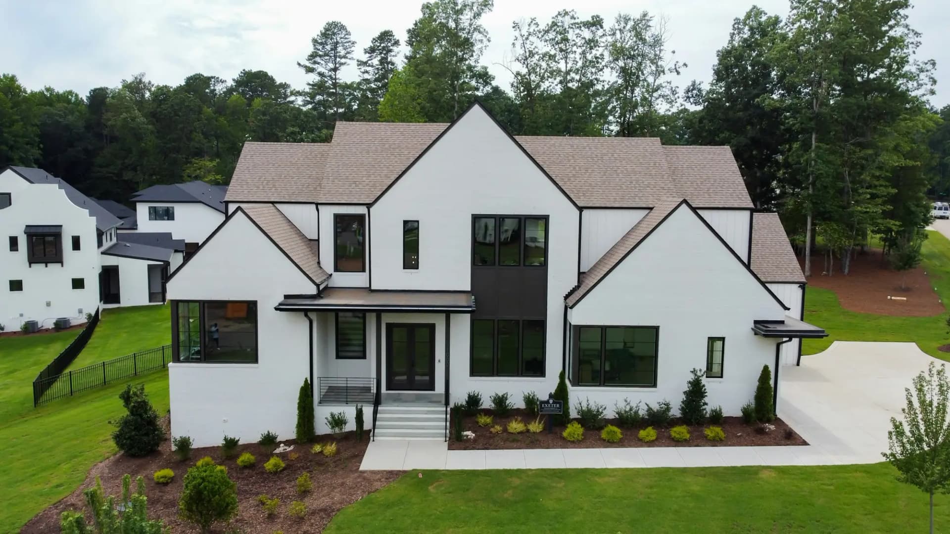 Modern farmhouse-style custom home with white board-and-batten siding