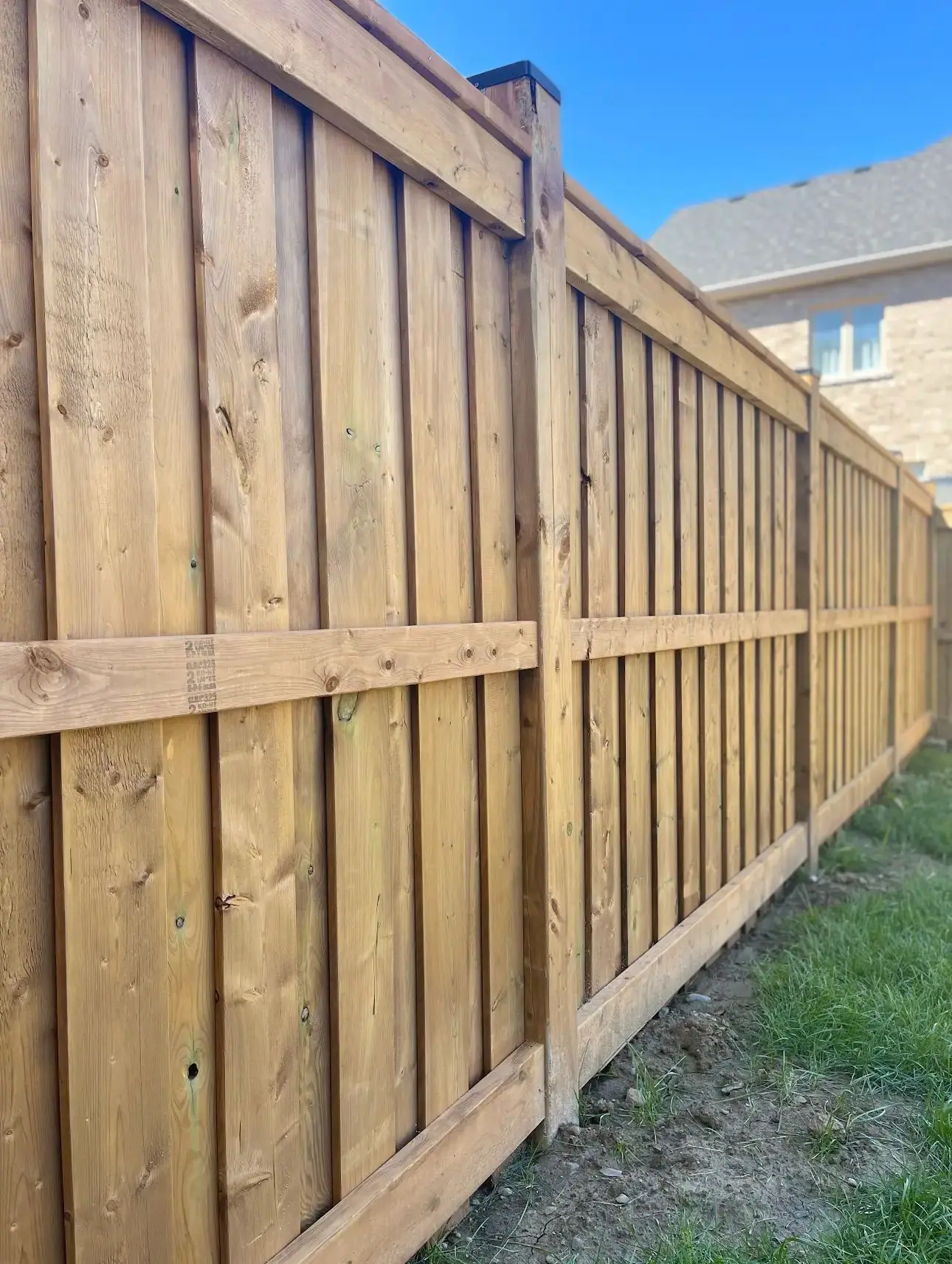 Close-up of pressure-treated fence boards and posts