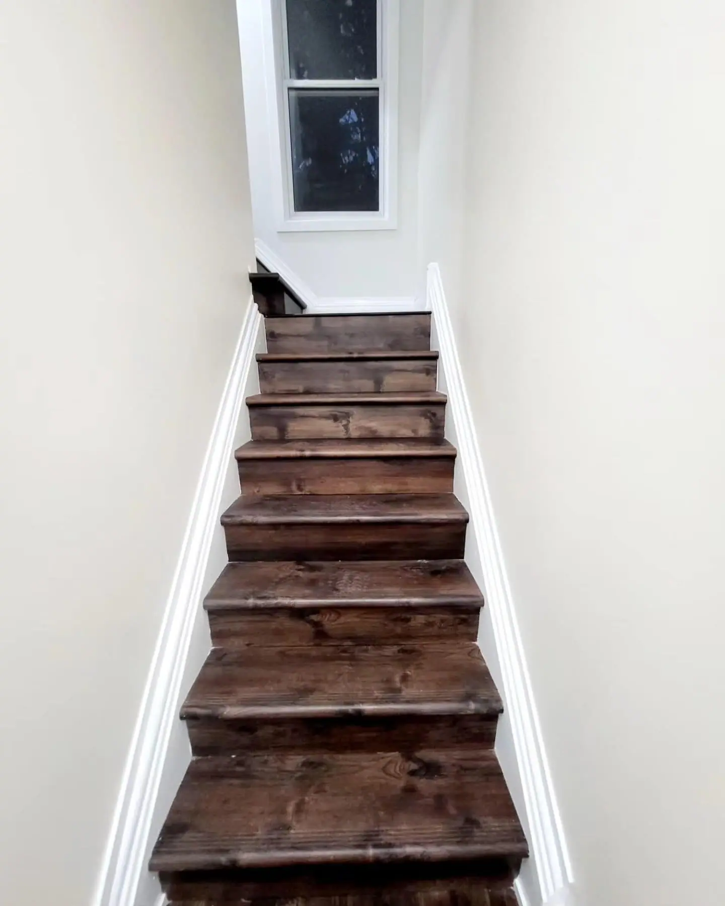 Refinished stairs with dark-stained treads