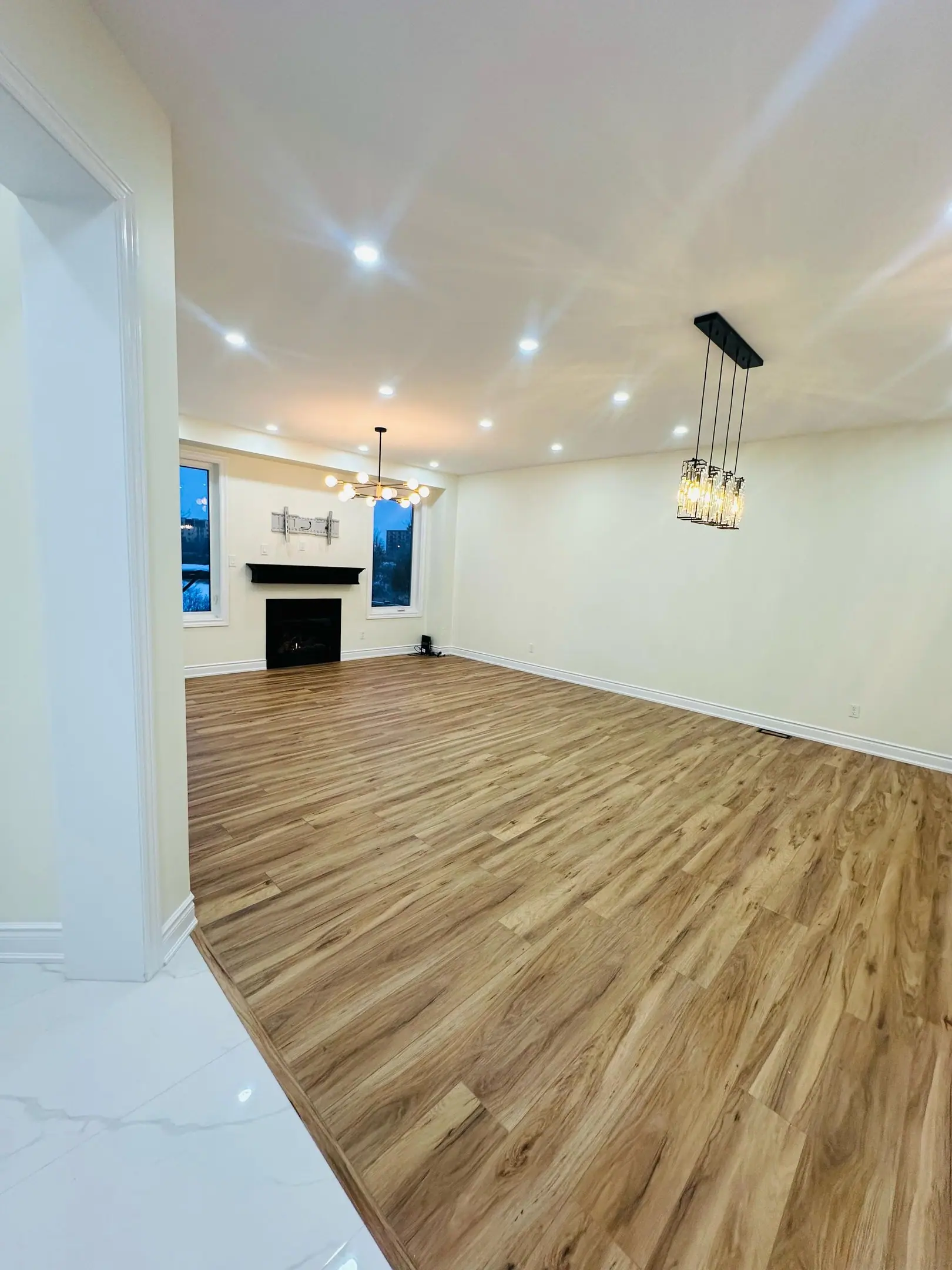 Main-floor living room with pendant lights and new flooring