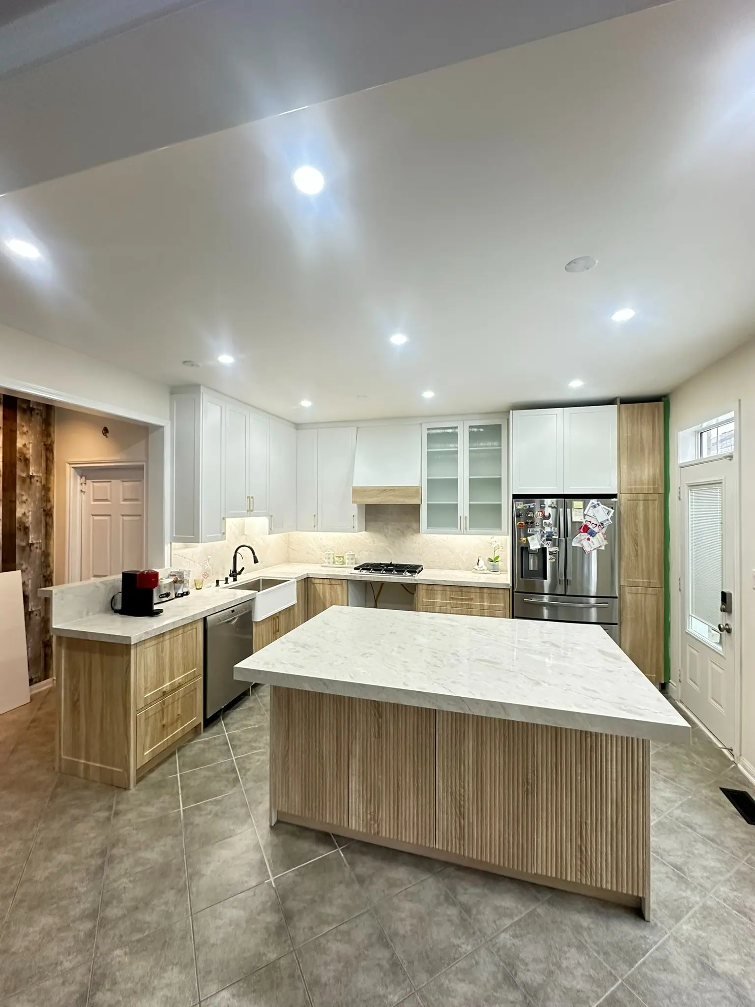 Kitchen with natural wood island and white perimeter cabinets