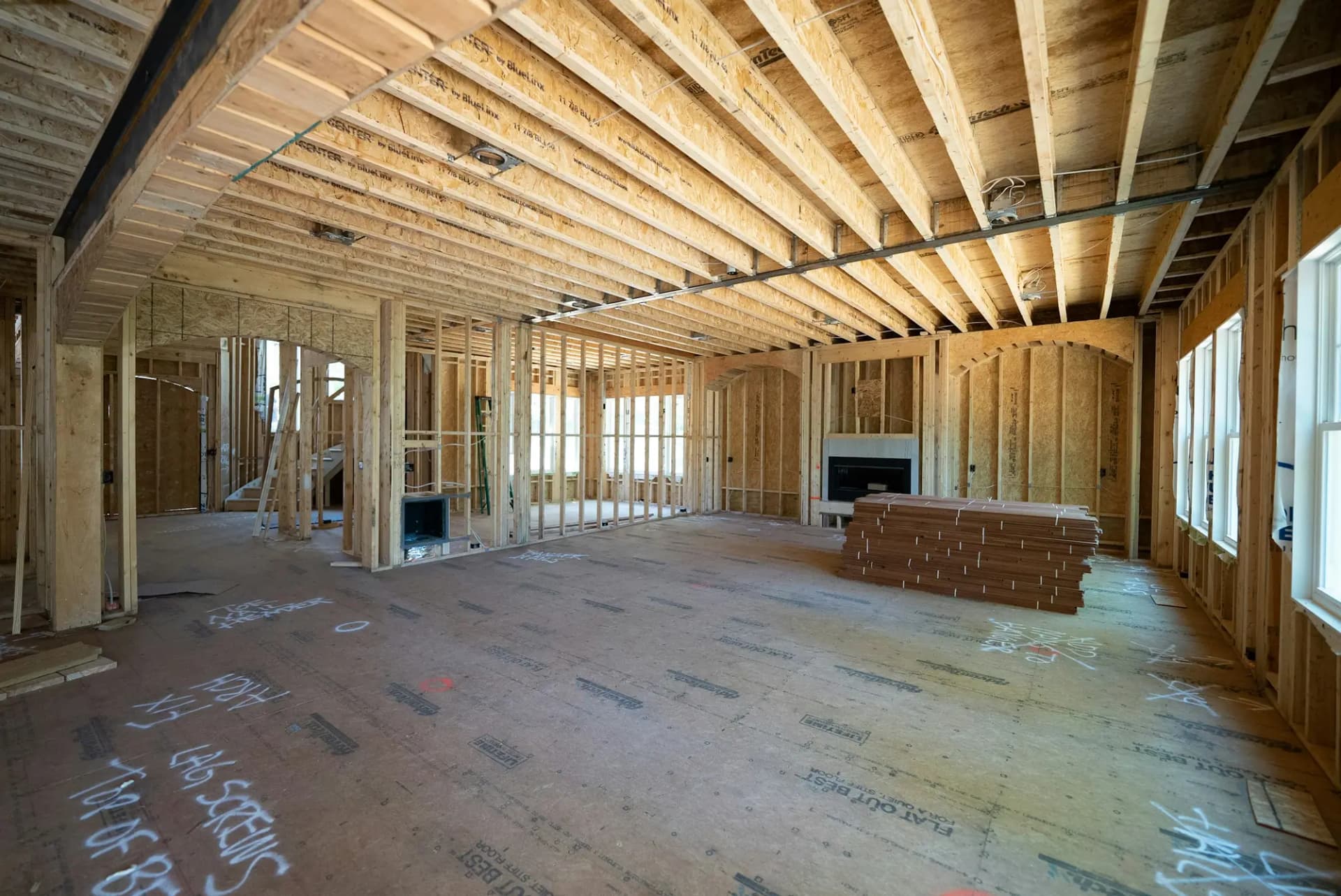 Framed walls and open-web floor joists inside a new home under construction