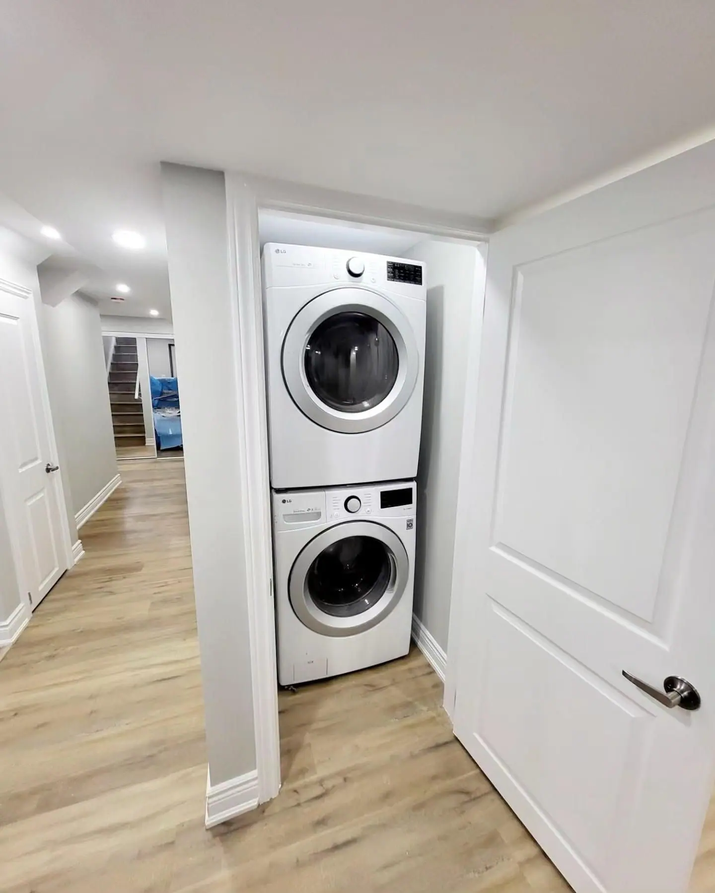 Stacked laundry closet in a finished basement suite