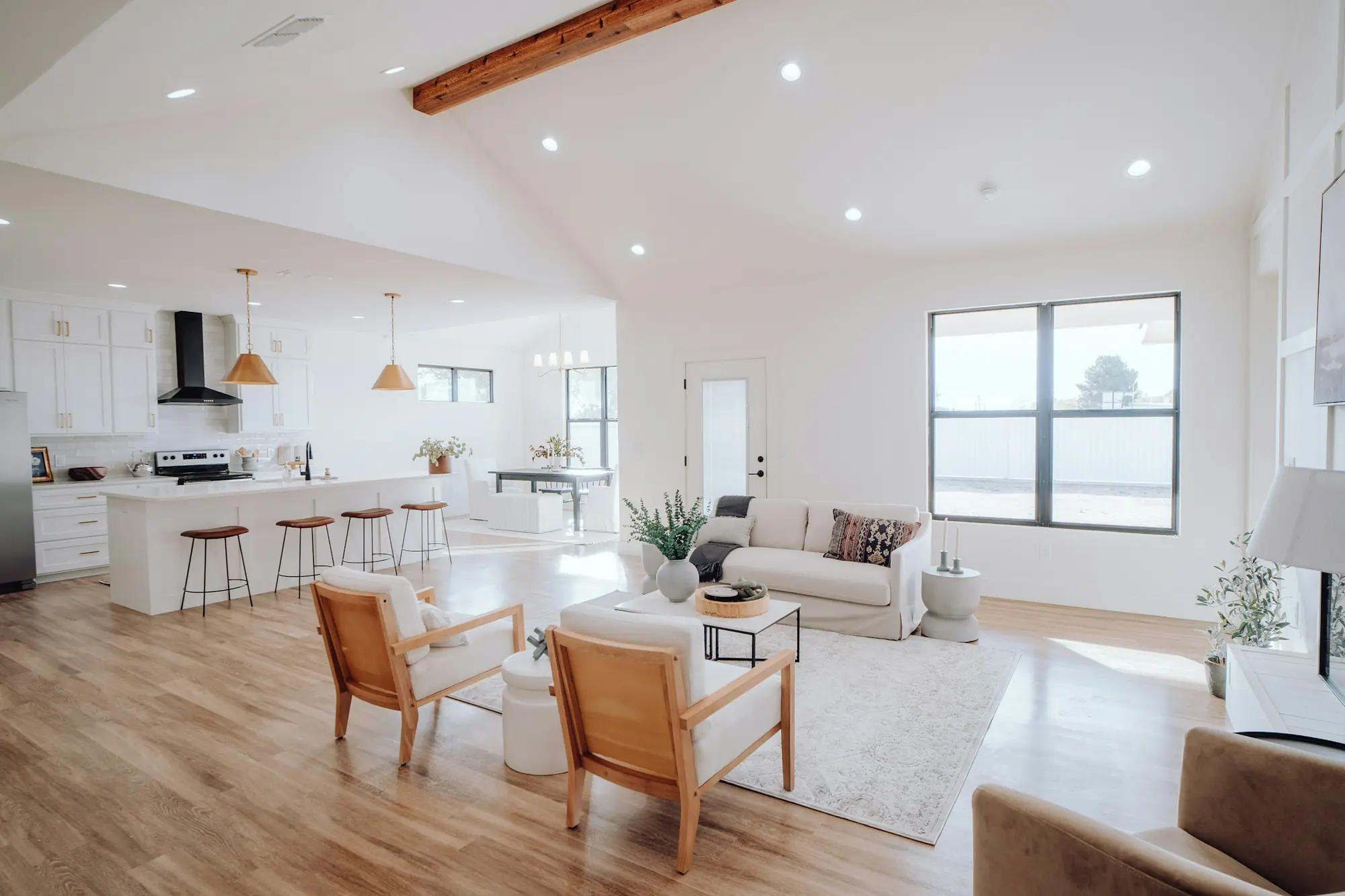 Bright open-concept living room and kitchen in a new custom home