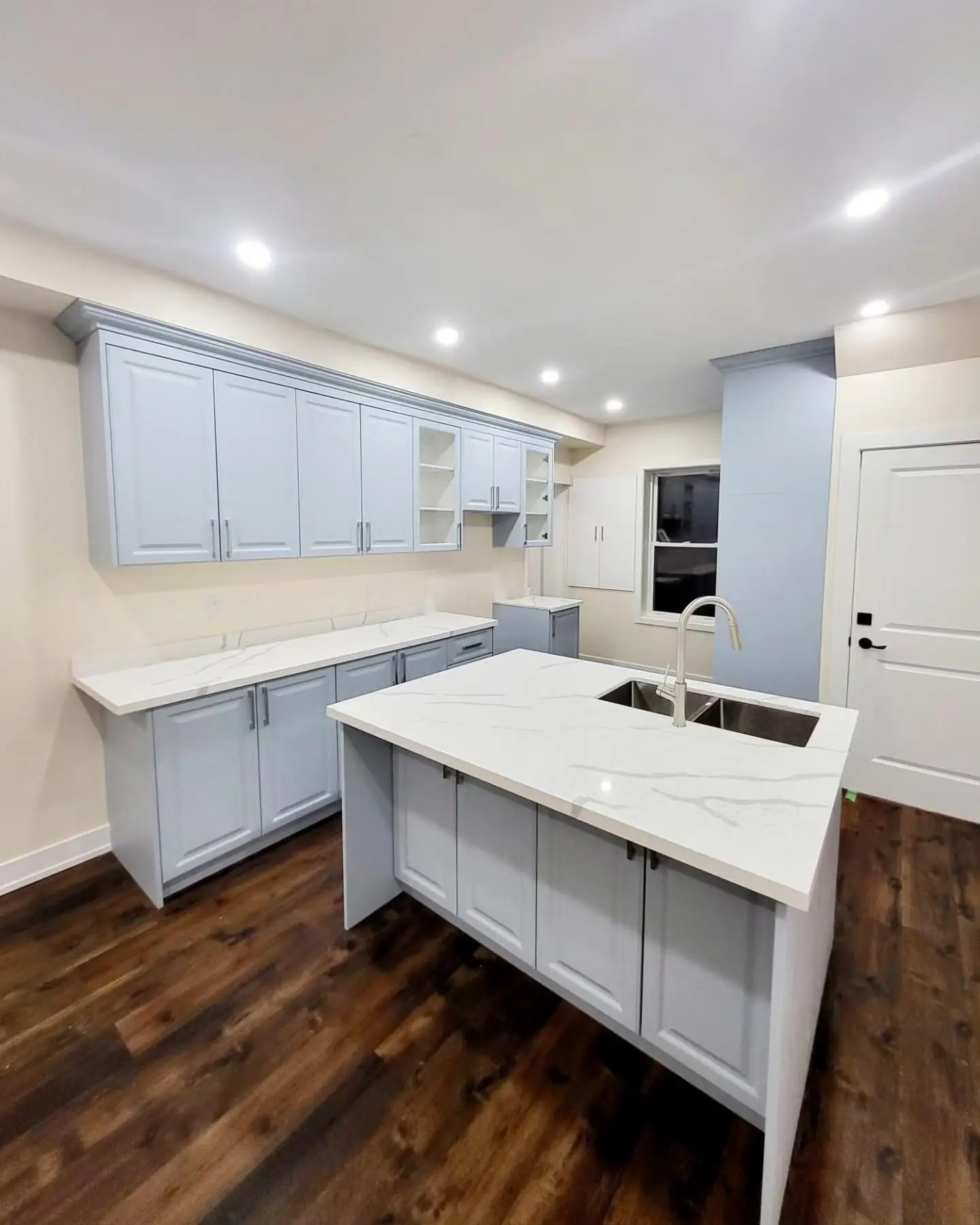 Grey and white kitchen with quartz island